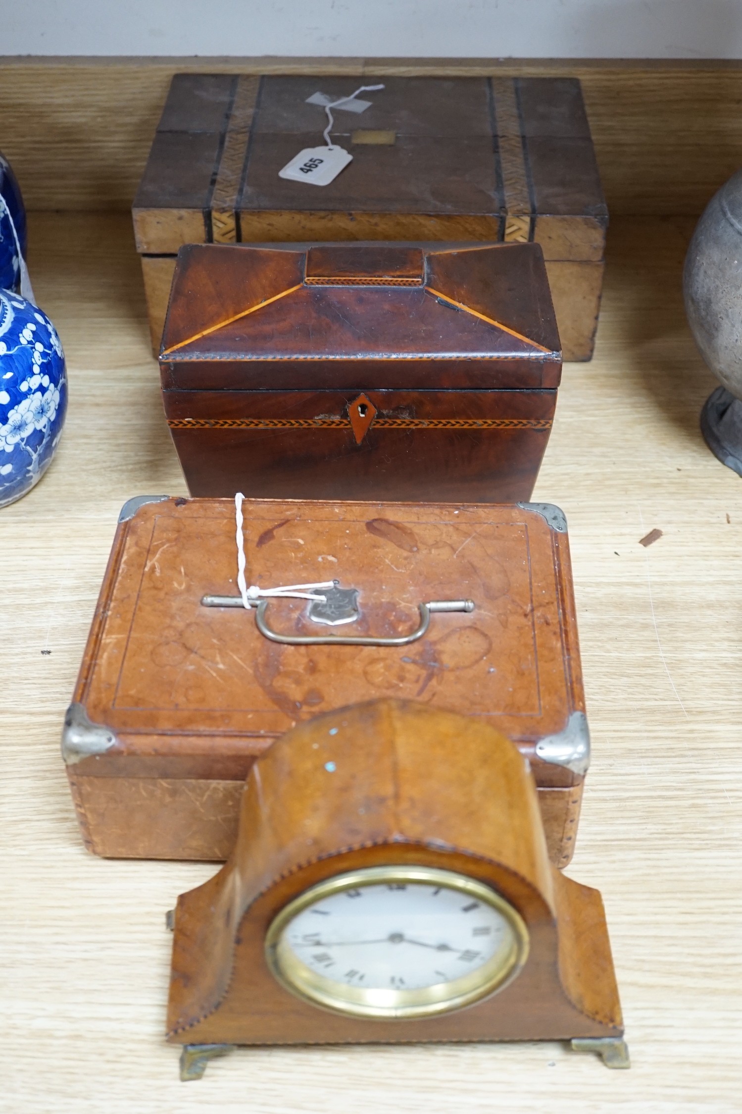 A 19th century mahogany tea caddy, writing slope, leather box and mantel clock, largest 30cm wide